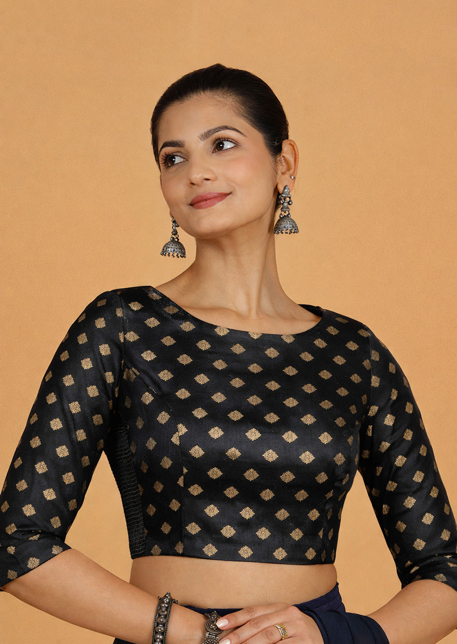 Dhara x Tyohaar Saree Blouse, in Black Butta Satin Viscose, featuring three quarter sleeves and boat neckline.