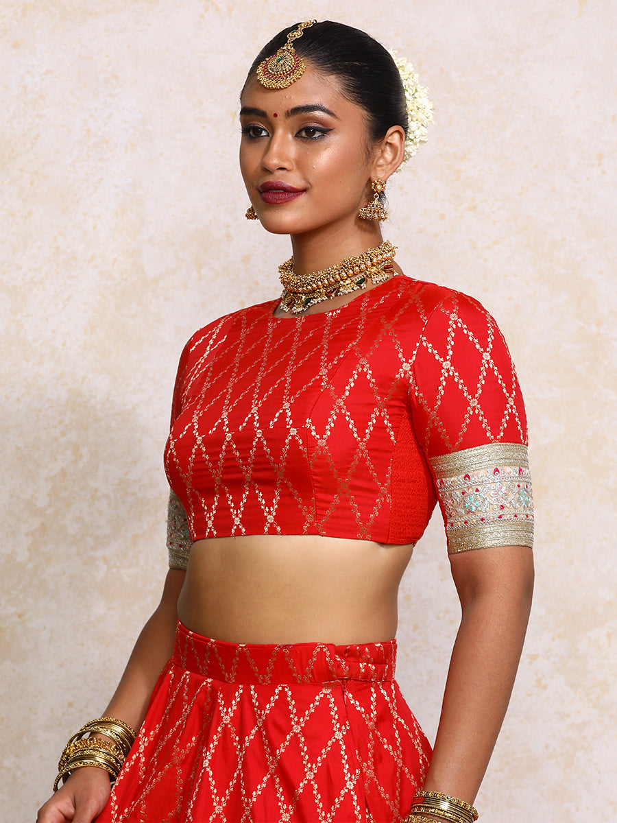 Kashvi x Tyohaar Saree Blouse, in Red Viscose Silk Brocade, featuring elbow sleeves and jewel neckline.