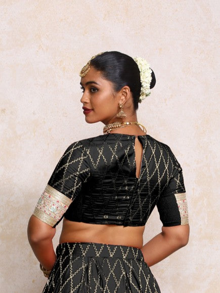 Kashvi x Tyohaar Saree Blouse, in Black Viscose Silk Brocade, featuring elbow sleeves and jewel neckline (view 2).