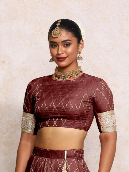 Kashvi x Tyohaar Saree Blouse, in Maroon Viscose Silk Brocade, featuring elbow sleeves and jewel neckline.