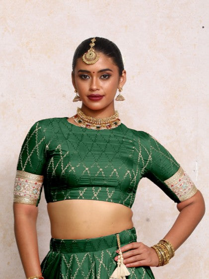 Kashvi x Tyohaar Saree Blouse, in Green Viscose Silk Brocade, featuring elbow sleeves and jewel neckline.
