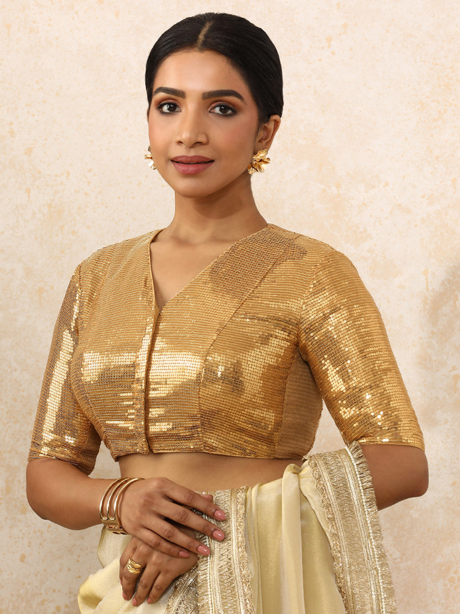 Sunidhi x Tyohaar Saree Blouse, in Gold Sequin Fabric, featuring elbow sleeves and v-neckline, made for party & festive.