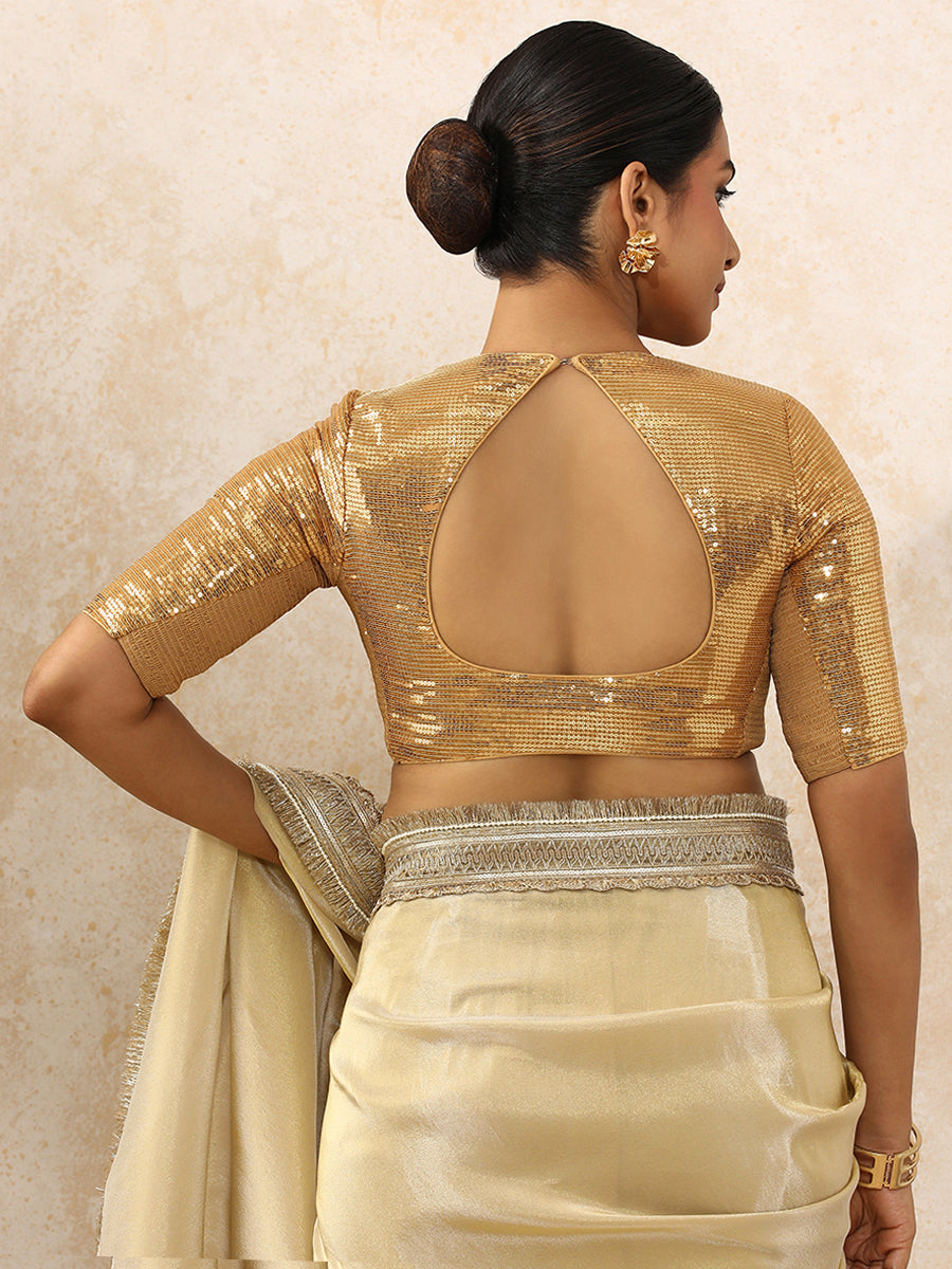 Yashvi x Tyohaar Saree Blouse, in Gold Sequin Fabric, featuring elbow sleeves and pot neckline, made for party & festive.