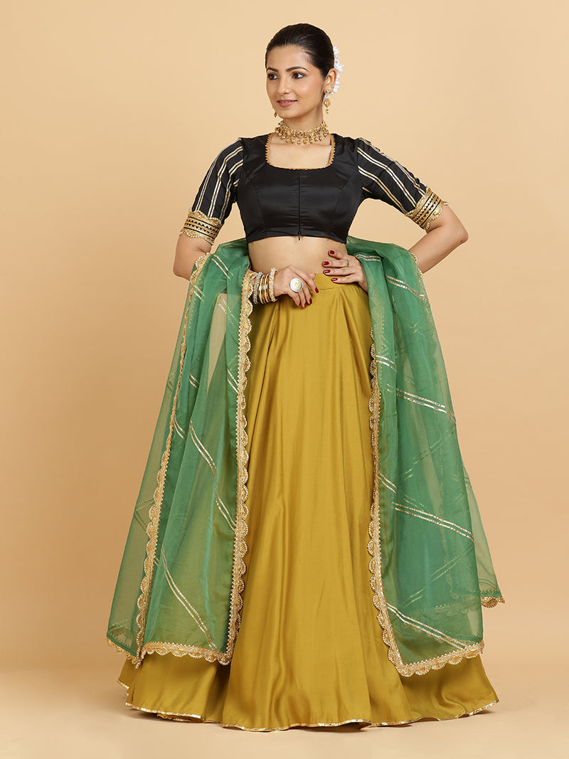 Jhalak Aziza 4-Pc Lehenga Set x Tyohaar | Mustard Lehenga, Charcoal Black Blouse with Emerald Panna Dupatta and Cancan Skirt-Binks