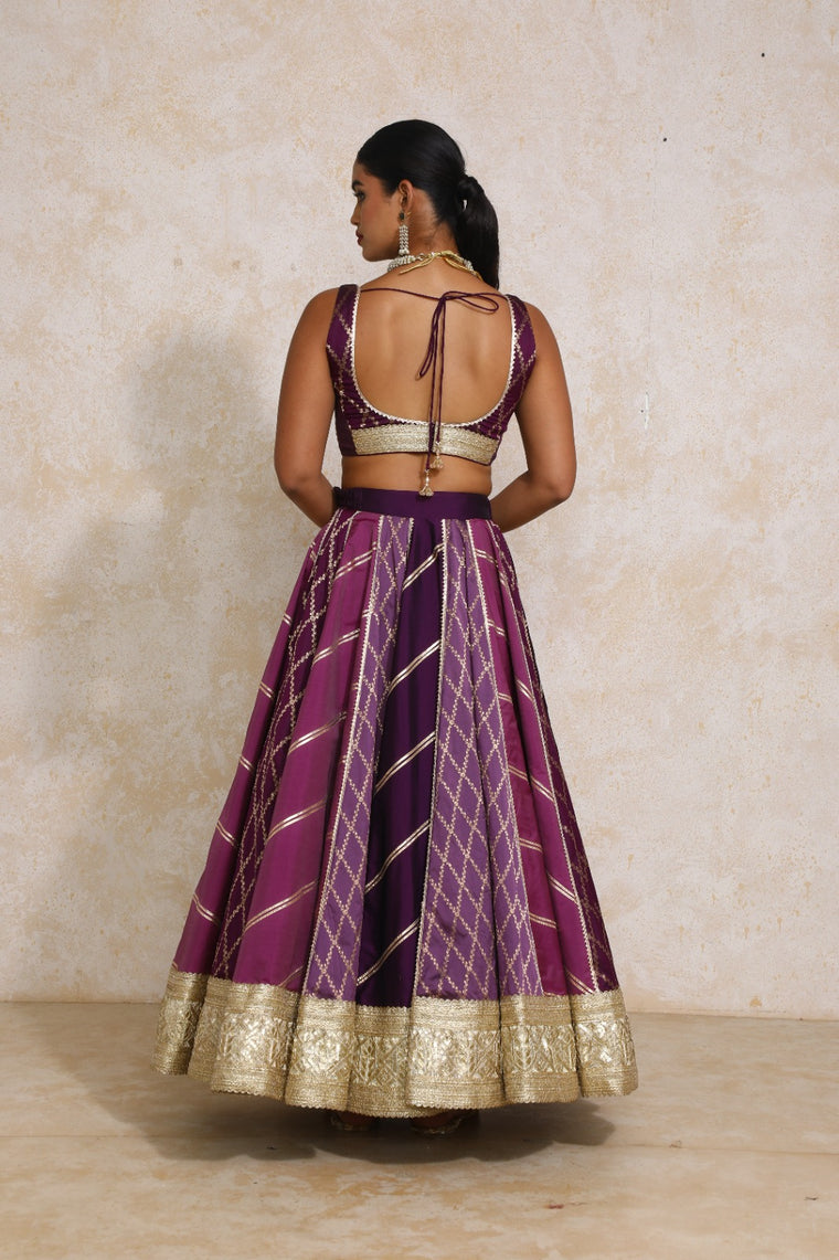 Raahi x Tyohaar Lehenga Set, in Purple Viscose Silk Brocade, featuring sleeveless and curved v-neckline (view 2).