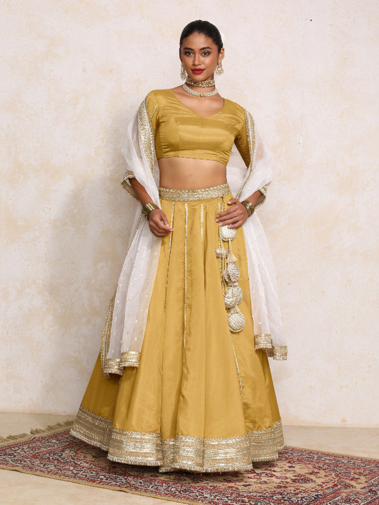 Ruhani x Tyohaar Lehenga Set, in Yellow Viscose Gold Tissue, featuring elbow sleeves and v-neckline.