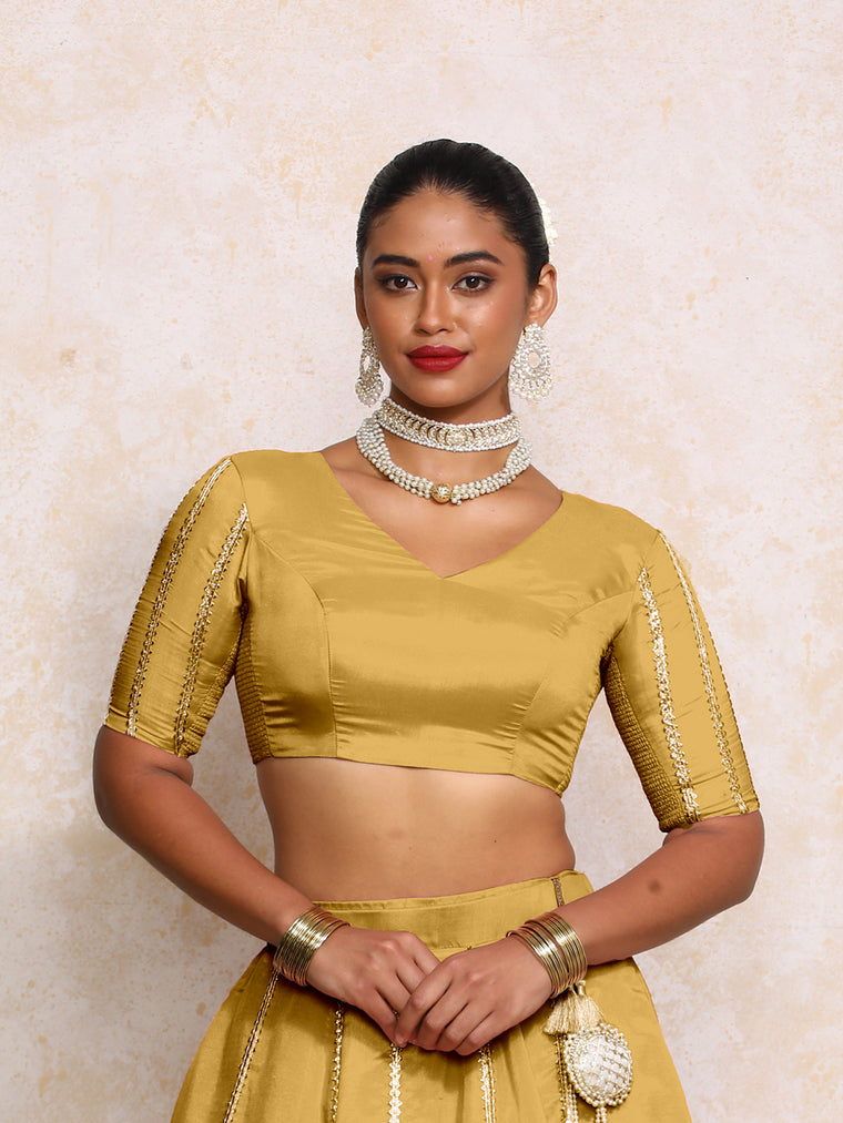 Aashni x Tyohaar Saree Blouse, in Yellow Viscose Gold Tissue, featuring elbow sleeves and v-neckline.