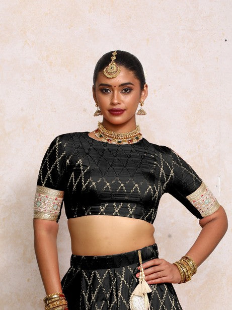 Kashvi x Tyohaar Saree Blouse, in Black Viscose Silk Brocade, featuring elbow sleeves and jewel neckline.