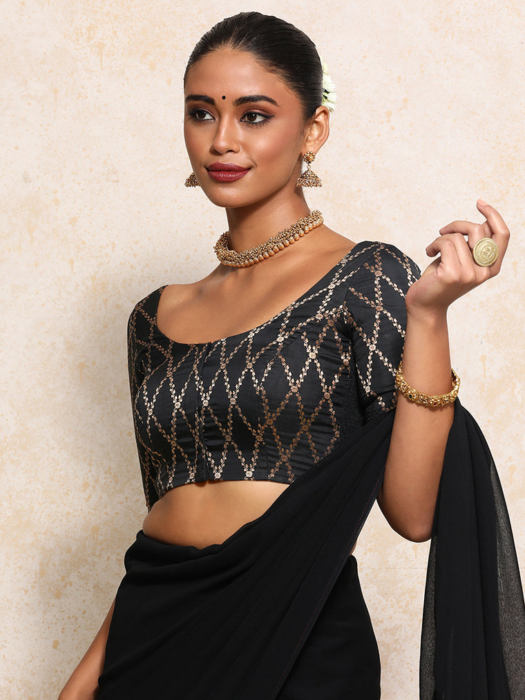 Kumkum x Tyohaar Saree Blouse, in Black Viscose Silk Brocade, featuring elbow sleeves and round neckline.
