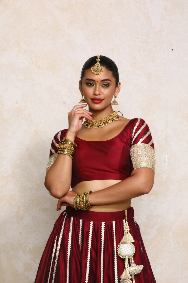 Manika x Tyohaar Saree Blouse, in Maroon Chandheri, featuring elbow sleeves and scoop neckline, made for party & festive.