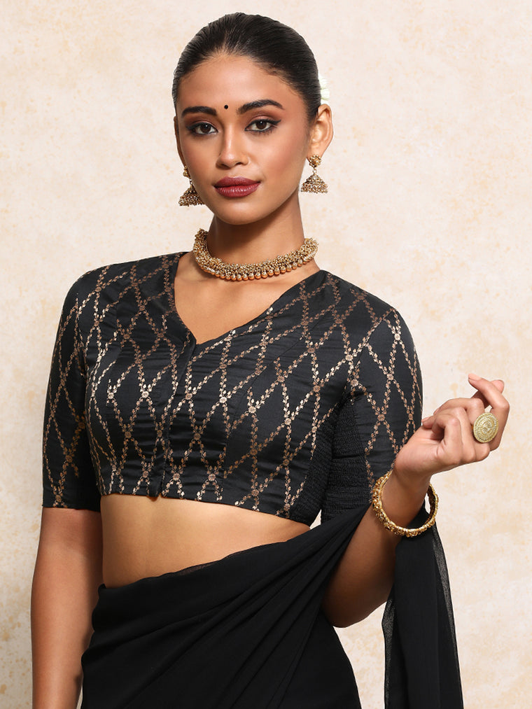 Manisha x Tyohaar Saree Blouse, in Black Viscose Silk Brocade, featuring elbow sleeves and v-neckline.