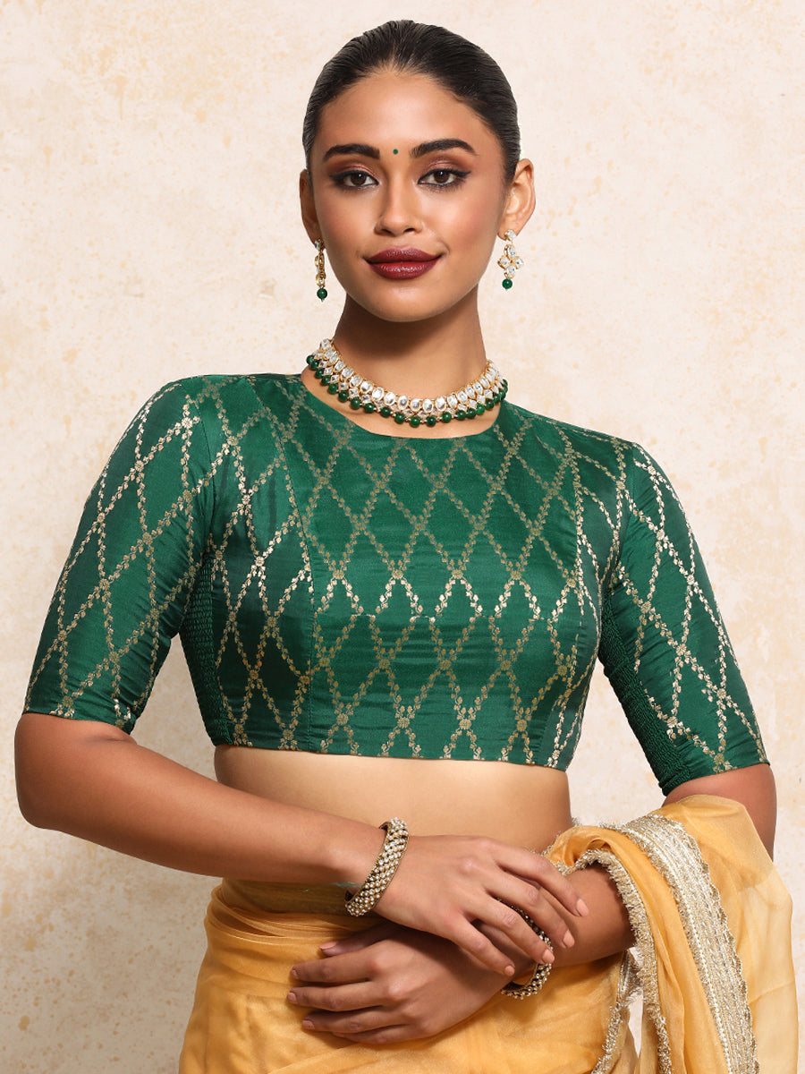 Reena x Tyohaar Saree Blouse, in Green Viscose Silk Brocade, featuring elbow sleeves and jewel neckline.