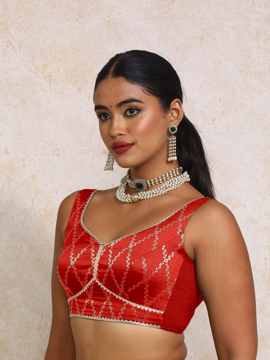 Rivana x Tyohaar Saree Blouse, in Red Viscose Silk Brocade, featuring sleeveless and sweetheart neckline.