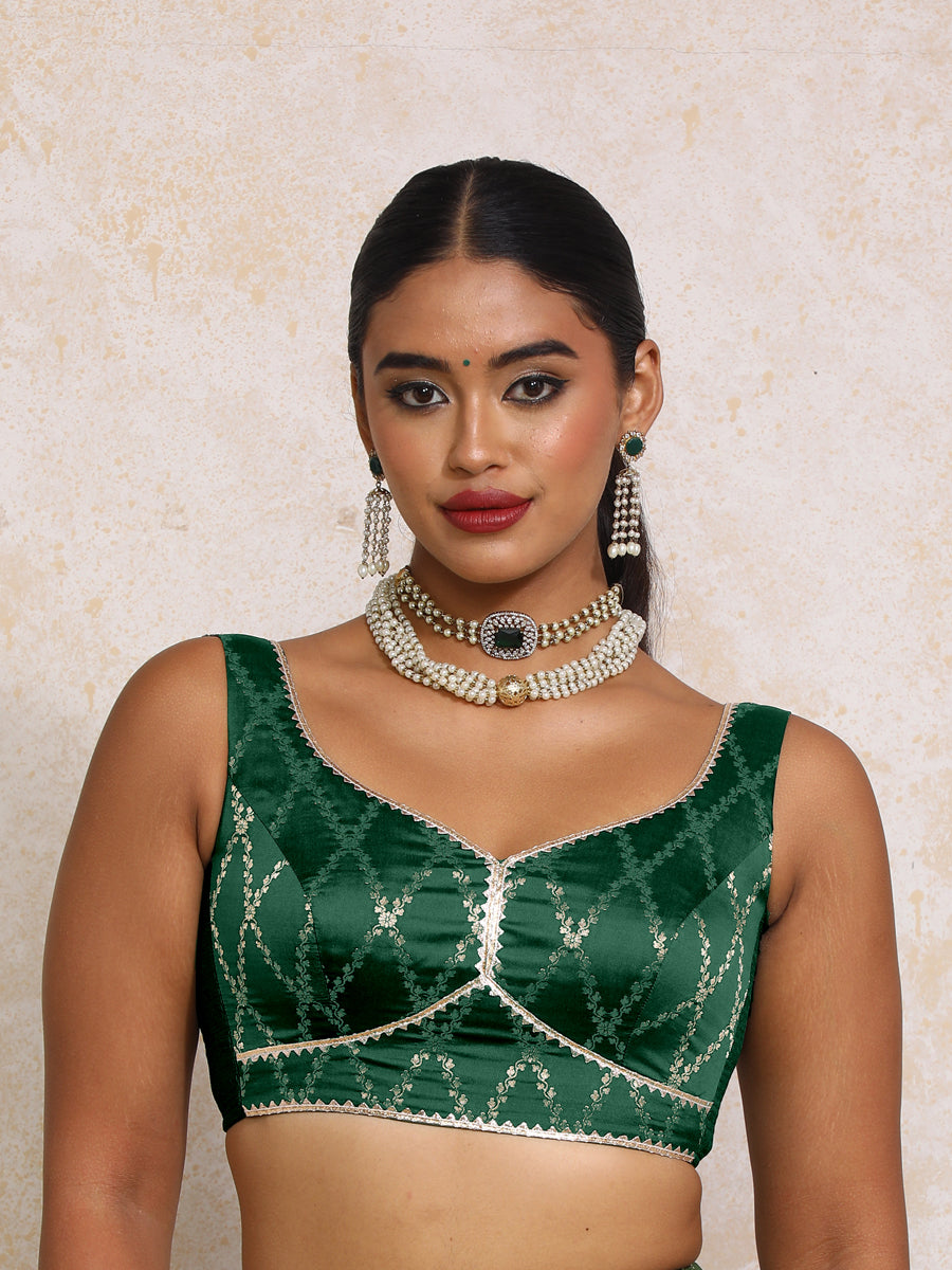 Rivana x Tyohaar Saree Blouse, in Green Viscose Silk Brocade, featuring sleeveless and sweetheart neckline.