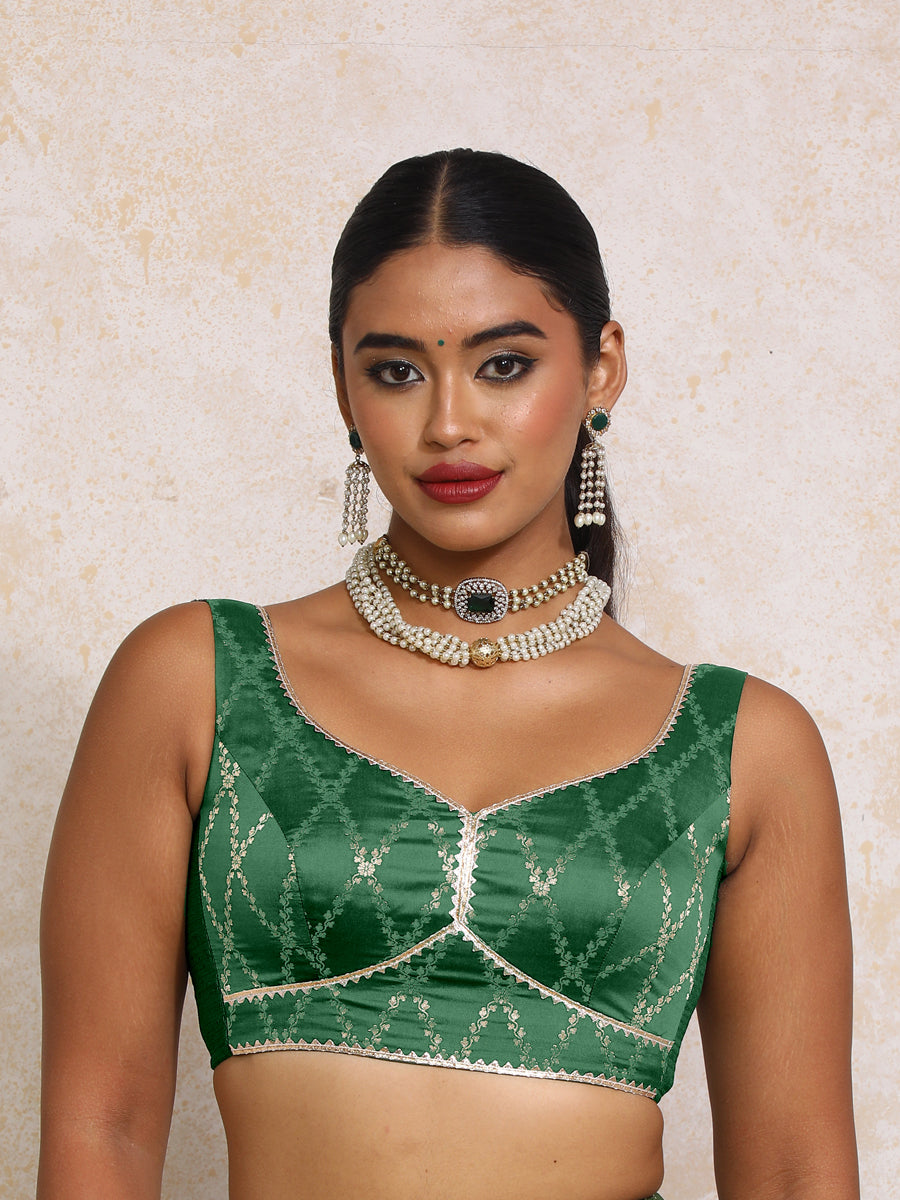 Rivana x Tyohaar Saree Blouse, in Green Viscose Silk Brocade, featuring sleeveless and sweetheart neckline.