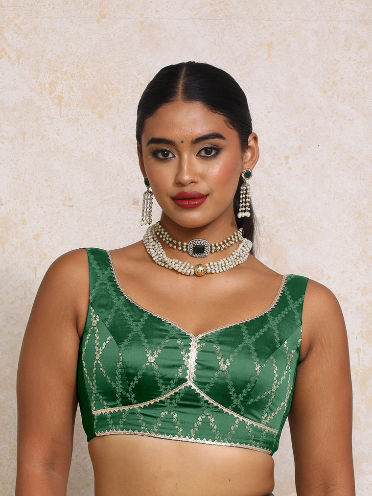 Rivana x Tyohaar Saree Blouse, in Green Viscose Silk Brocade, featuring sleeveless and sweetheart neckline.