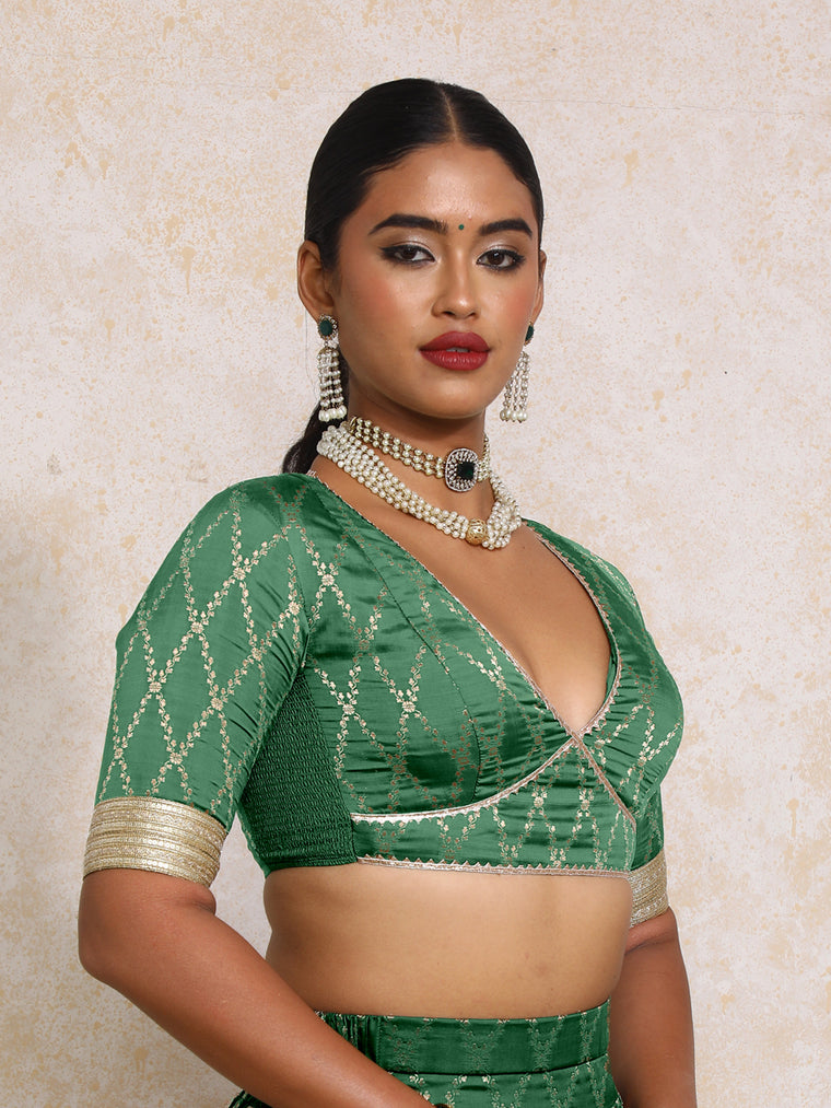 Rivya x Tyohaar Saree Blouse, in Green Viscose Silk Brocade, featuring elbow sleeves and v-neckline.