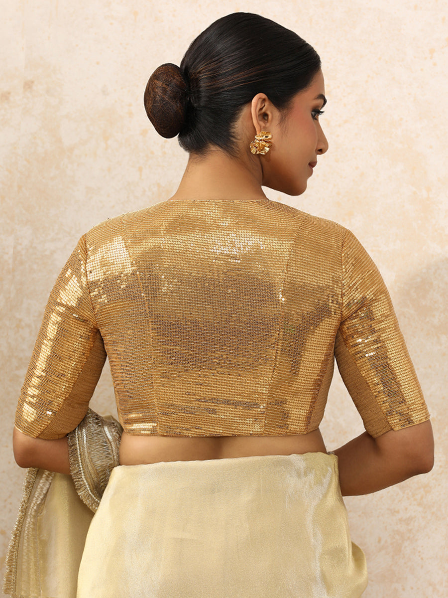Sunidhi x Tyohaar Saree Blouse, in Gold Sequin Fabric, featuring elbow sleeves and v-neckline, made for party & festive.