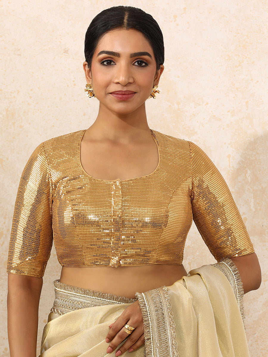 Yashvi x Tyohaar Saree Blouse, in Gold Sequin Fabric, featuring elbow sleeves and pot neckline, made for party & festive.