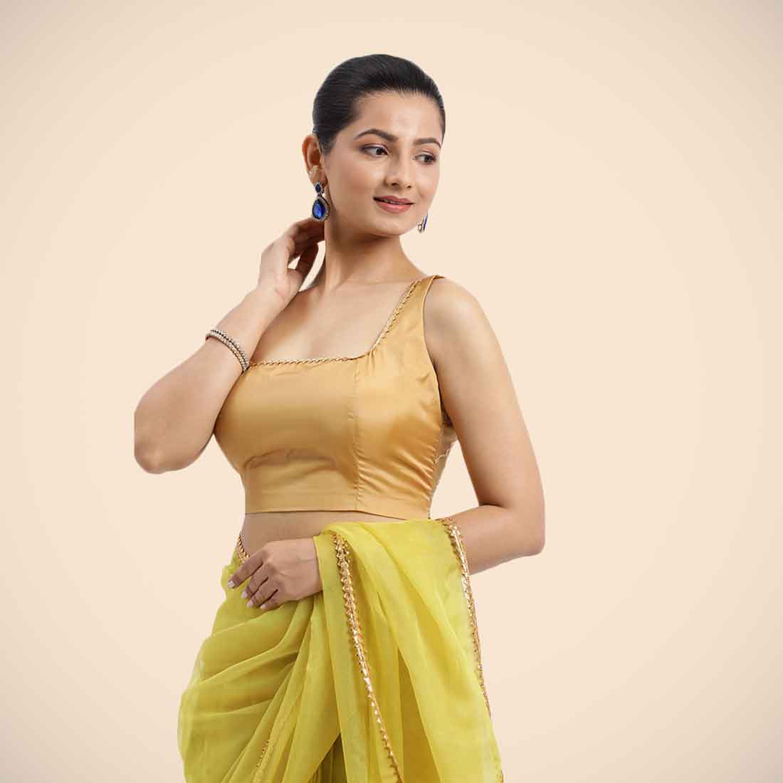 Zeba x Tyohaar Saree Blouse, in Gold Vegan Silk, featuring sleeveless and square neckline, made for party & festive.